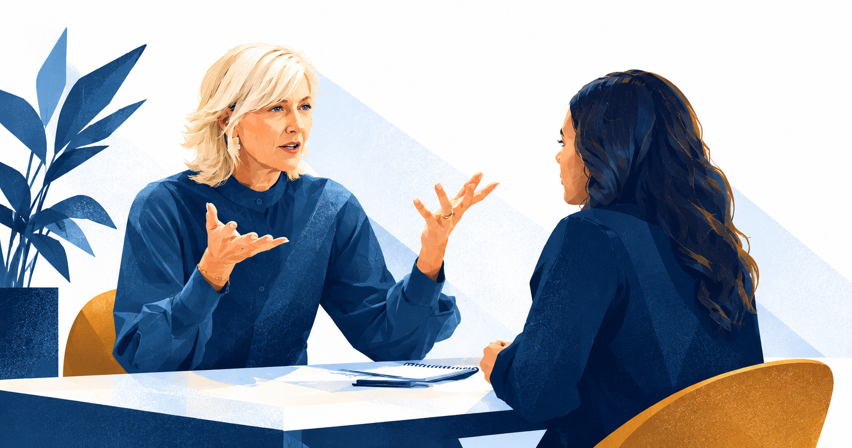 A manager talking through a performance review with an employee across a desk